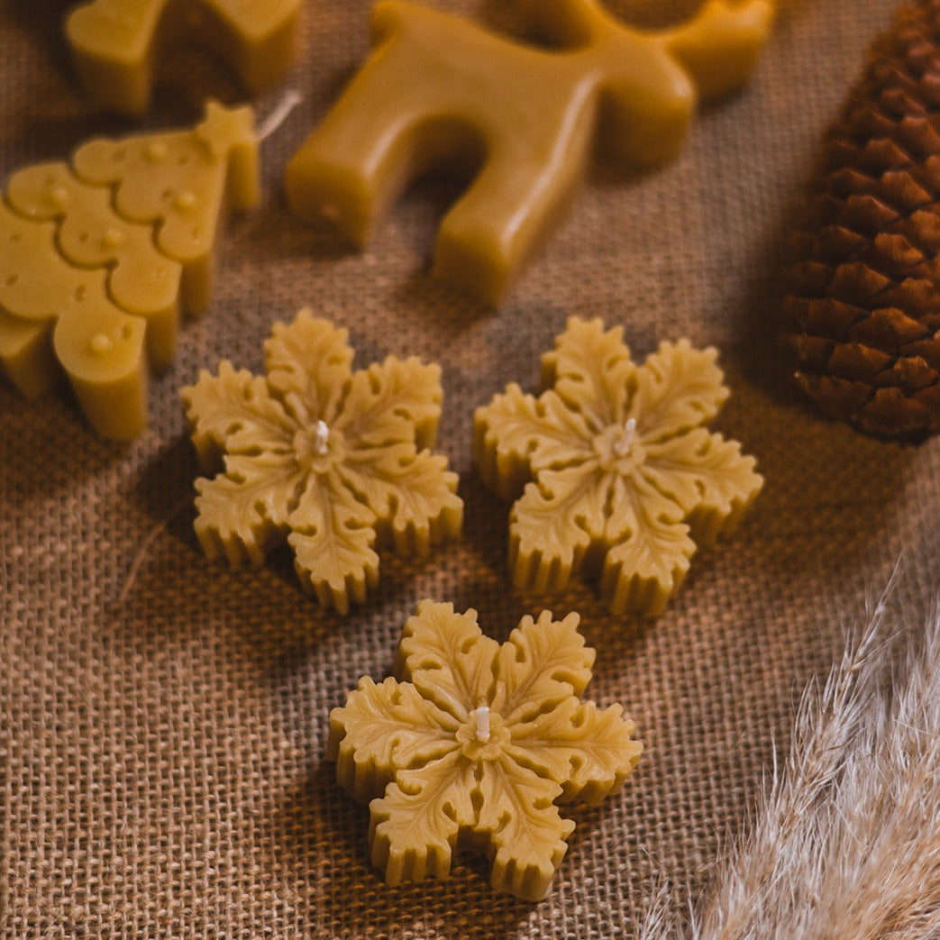 Beeswax Snowflake Christmas Candles, Set of Three on festive background