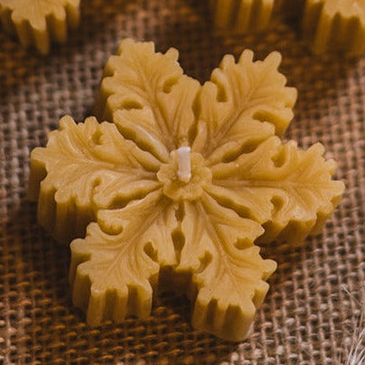 Beeswax Snowflake Christmas Candles, Set of Three on festive background