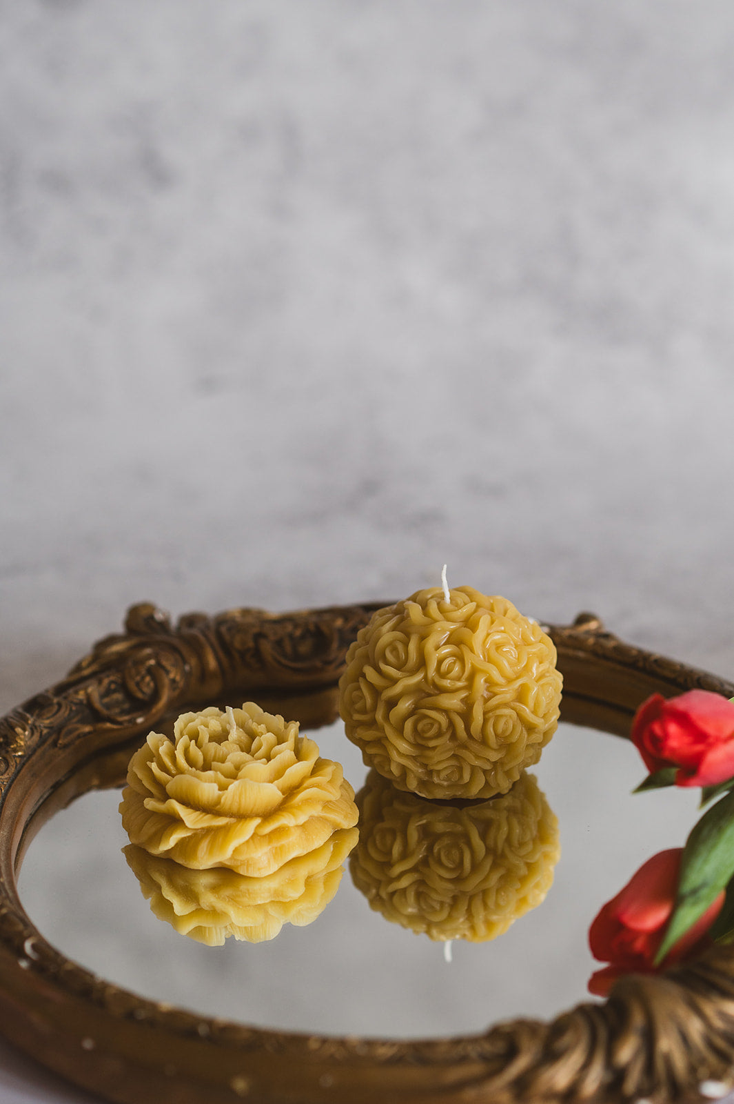 Flower Ball Beeswax Candle and Rose Beeswax Candle on a mirror